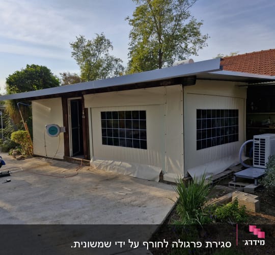 סוכך בד לבן עם חלונות שקופים על מבנה חיצוני
